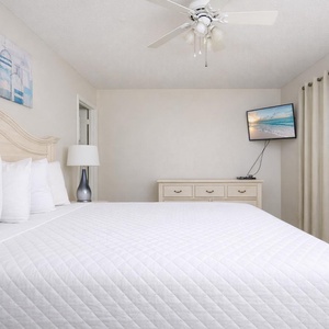 Relax in the soft king bed in the guest suite, drifting into peaceful sleep while a favorite show plays on the TV
