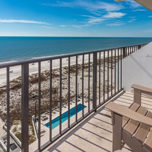 Enjoy breathtaking beachfront views from the balcony, complete with comfortable seating and a glimpse of the pool below