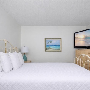 Drift off to sleep on the plush queen bed in the guest room, with a cozy vibe and coastal decor
