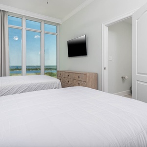 Open the tall drapes and wake on soft queen beds while you watch the gulf and shoreline from this guest room