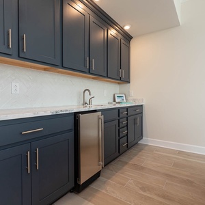 Make a chilled drink at the wet bar and pull a cold bottle from the undercounter fridge