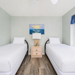 Twin beds in this guest suite invite peaceful rest after a day spent exploring coastal shores nearby
