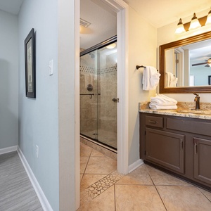 The master bath features a walk-in shower, elegant granite countertops, and a flat-screen TV for your convenience