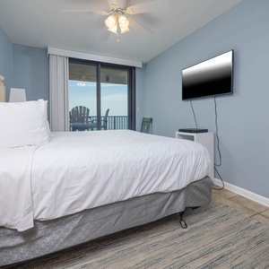 Brightly colored walls complement the inviting king bed in the master suite, with beach balcony access enhancing the vibe