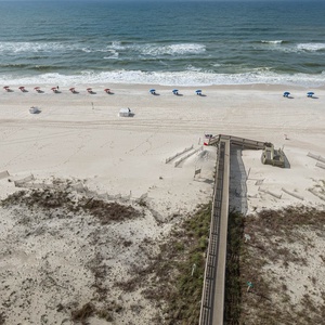Stroll along the beach, where colorful umbrellas invite relaxation and gentle waves create a soothing atmosphere