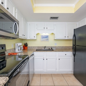Granite counters invite you to prepare fresh coastal meals in the kitchen