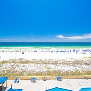 Relax on your balcony as seabirds call and the shore stretches endlessly beneath clear skies