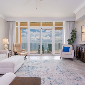 Sink into plush seating while taking in the beautiful coast views through expansive windows in this inviting living space