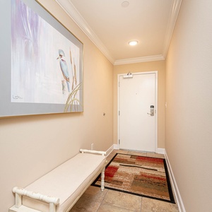 Step into a welcoming entryway, where artwork and a cozy bench set the stage for your coastal escape