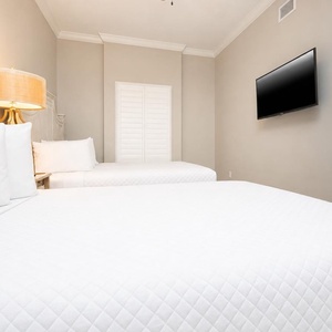 Sleep soundly on the queen beds, for a peaceful night in this tranquil guest bedroom