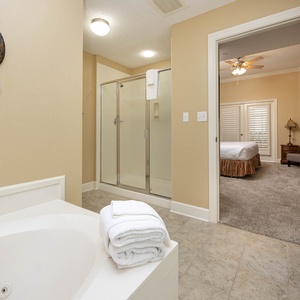 Refresh in the master bath after a day at the beach with a soothing jetted tub and relaxing walk-in shower