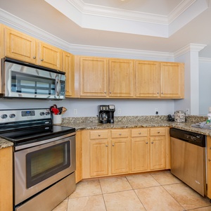 Inviting kitchen with stainless appliances, granite countertops, and a cozy coffee station for your morning brew
