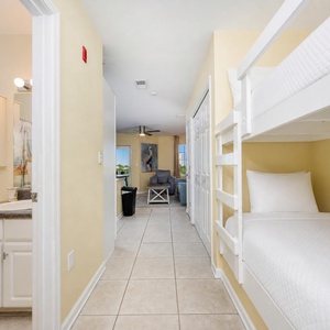 Soft linens invite kids to dream in the bunk area while the living room awaits your evening unwind