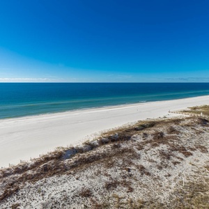 Gaze at the tranquil waters and expansive shoreline from your comfortable balcony retreat