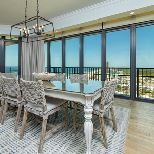 Gather your family around the elegant dining table, enjoying the coastal vibe and views through expansive windows