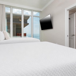 Wake up to stunning beach views in this queen guest suite and enjoy a movie after a day at the beach