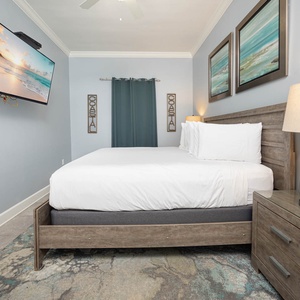 Relax in this inviting guest bedroom featuring a king bed, a TV for entertainment, and coastal decor