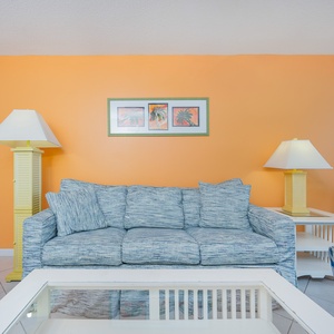 Sink into the plush sofa with a queen sleeper, surrounded by cheerful decor, and feel the beach vibe