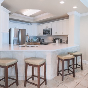 Gather around the inviting kitchen bar with comfortable seating, perfect for casual meals and conversations