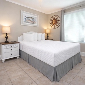 This cozy bedroom features a comfortable bed, warm lighting, and charming decor, perfect for a restful getaway