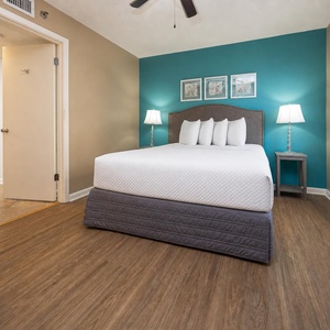 Inviting guest bedroom featuring a comfortable queen bed, stylish decor, and natural light from the window