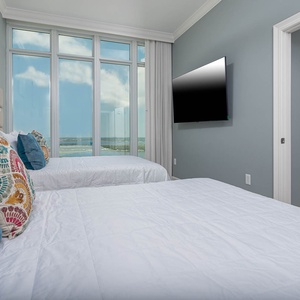Lie back on the queen bed and take in the gulf and distant shore through this guest room