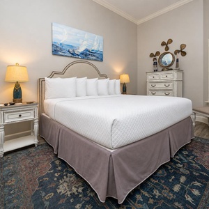This guest bedroom features a king bed with crisp white linens, stylish decor, and a cozy atmosphere perfect for relaxation
