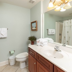 Pamper yourself with a refreshing rinse in the sleek bathroom, surrounded by soft towels and calming decor