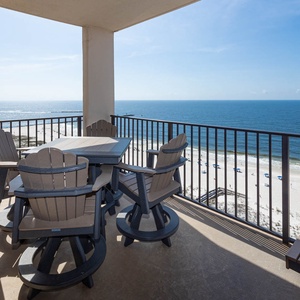 Enjoy meals on the balcony while taking in sweeping views of the sparkling waters and beach below