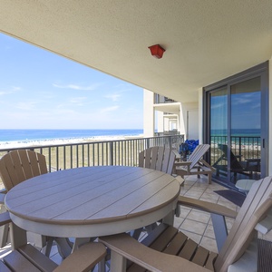 Relax on the balcony with a round table and chairs, enjoying views of the beach and the tranquil gulf waters