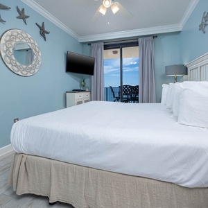 Retreat to this tranquil master suite featuring a plush king bed, calming decor, and a stunning beach view