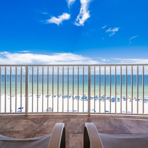 Breathe in the fresh gulf air while lounging on the balcony, with views of the beach and vibrant blue waters below