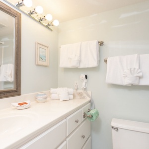 Guest bathroom featuring fresh towels, a sleek vanity, and a spacious shower area for a relaxing retreat