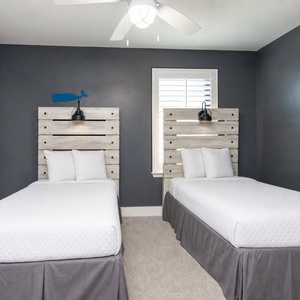 Cozy twin guest bedroom featuring stylish wood headboards and soft lighting for a restful night's sleep