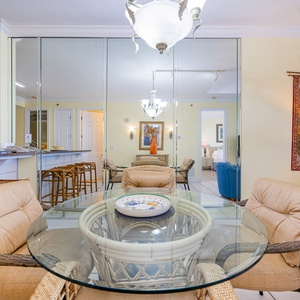 Glass-topped table invites you to relax and enjoy quiet moments in the dining area's cozy chairs