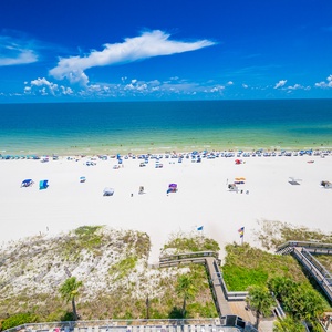 This stunning beachfront view showcases vibrant umbrellas on the soft white sand, perfect for a relaxing getaway