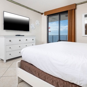 Relax in the inviting master bedroom, featuring a king bed and stylish decor, with beachfront access that enhances your stay