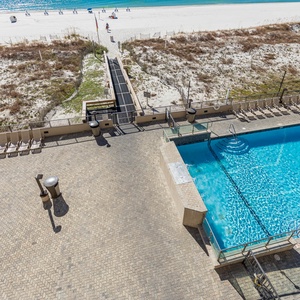 Relax by the inviting pool area with lounge chairs, just steps from the beach and sparkling waters