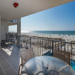 Savor your morning coffee at the table while enjoying views of the beach and the inviting pool area below