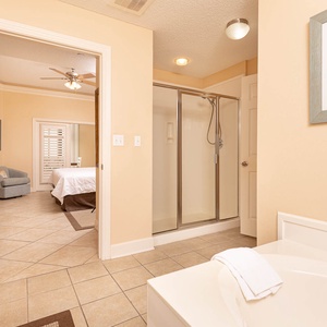 Refresh in the master bath after a day at the beach with a soothing jetted tub and relaxing walk-in shower