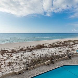 Take in the serene views of the water while relaxing by the inviting pool area, perfect for sunbathing and unwinding