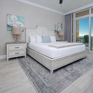 Retreat to the king master suite with cozy bedding and drift off to the sound of the waves from the balcony