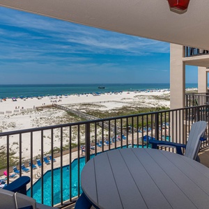 Relax on the balcony, enjoying views of the beach and the inviting pool below