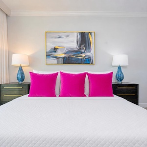 Embrace restful nights on the king in the master as soft lighting and coastal decor create a serene escape