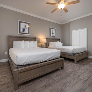Rest in the comfort of two queen beds in this guest room, creating a cozy retreat for relaxation after beach adventures