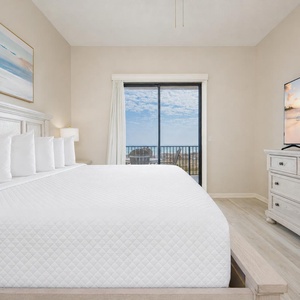 In this king master suite, your eyes rest on peaceful water views while a gentle breeze stirs the curtains