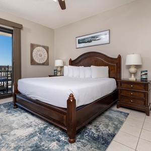 Relax in this inviting master bedroom featuring a king bed, tasteful decor, and beachfront ground floor patio