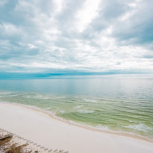 Gaze out at the tranquil coast from the spacious balcony, embodying peace and natural beauty during your stay