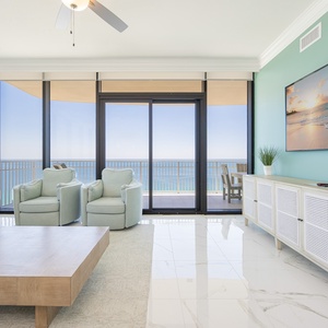 Relax in the inviting living area with plush seating and large windows that frame beautiful views of the beach