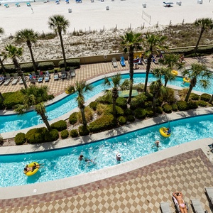 Colorful tubes float gently as you watch friends drift along the lazy river enjoying the sun